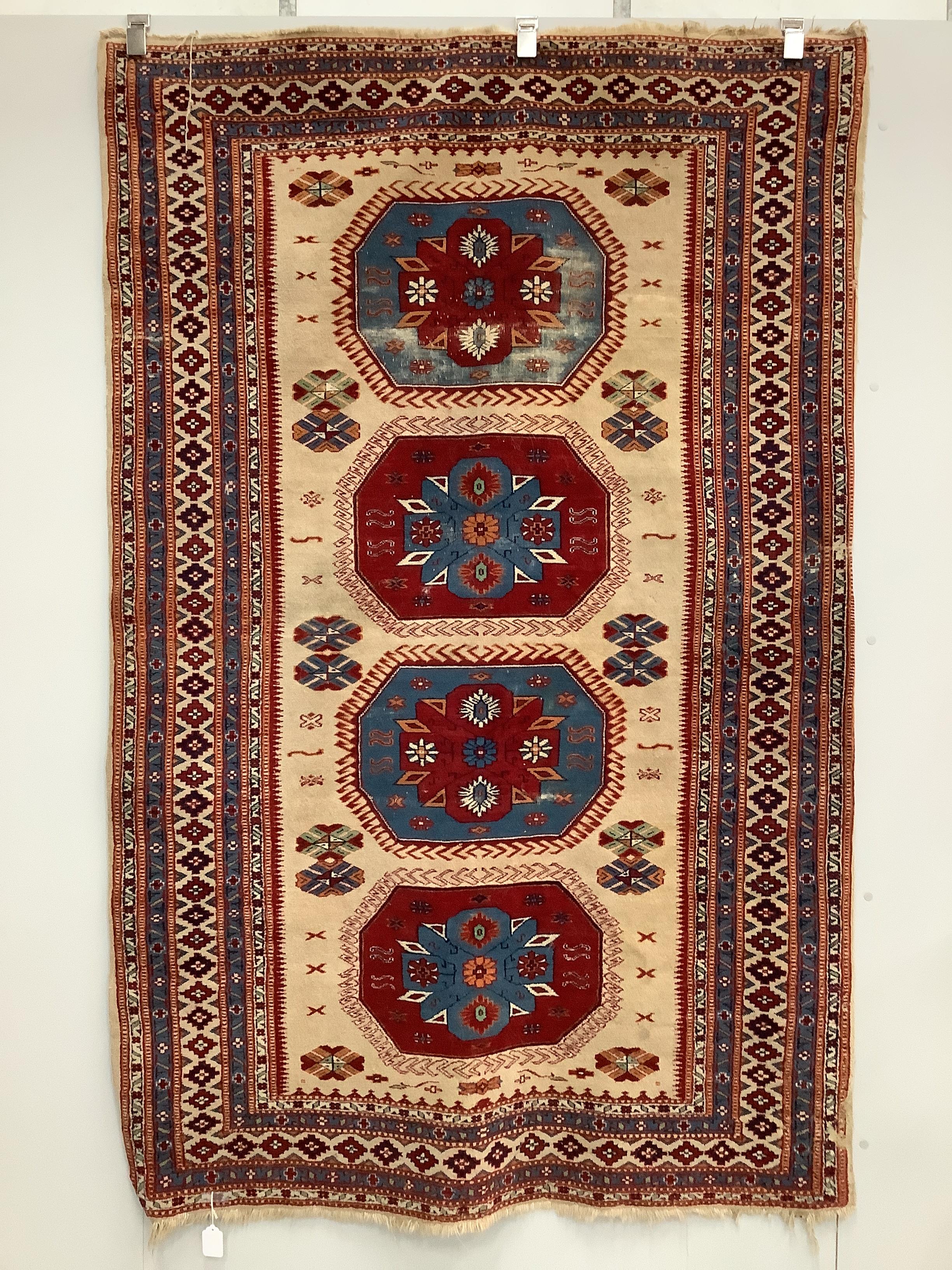 A Caucasian style fawn ground rug, 200 x 132cm